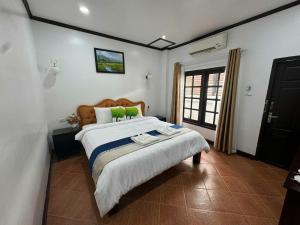 a bedroom with a large bed in a room at Win Hotel in Vang Vieng +72 photos