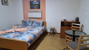 a bedroom with a bed and a table and chair at Apartments Doris in Kruševo