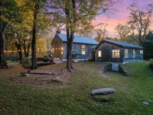 a house in the middle of a yard with trees at Modern Lux Cabin w Mtn Views and Fire Pit in Stratton