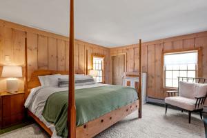 a bedroom with a bed and a chair at Modern Lux Cabin w Mtn Views and Fire Pit in Stratton