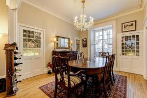 a dining room with a table and chairs and a chandelier at 2002 Les Immeubles Charlevoix - 2002 - Le Parloir in Quebec City