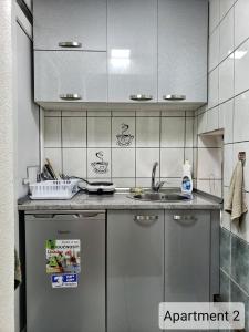 a kitchen with a refrigerator and a sink at Apartments Doris in Kruševo +17 photos