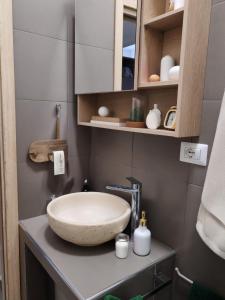 a bathroom with a bowl sink on a counter at Suite Malu in Naples