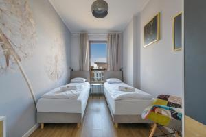 Posteľ alebo postele v izbe v ubytovaní Amber Baltic Apartment