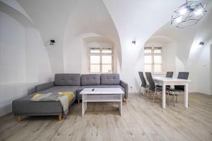 a living room with a couch and a table at St Elizabeth Apartment, Kosice Old Town in Košice