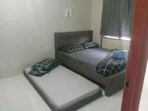 Postel nebo postele na pokoji v ubytování Inap KAMI HOMESTAY