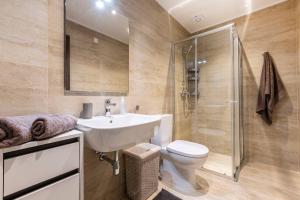 a bathroom with a sink and a toilet and a shower at Beautiful Modern Central 2BR Apt in Taʼ Xbiex +14 photos