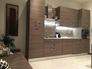 a kitchen with wooden cabinets and a sink at Ca' Novo in Venice