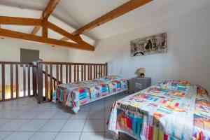 two beds in a room with a balcony at Villa Avec Piscine partagée in Cap d'Agde +17 photos