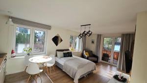 a bedroom with a bed and a table and chairs at Holiday Karpacz in Karpacz