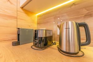 two coffee pots sitting on a counter in a room at Poiana Ski Residence Apartment 5 in Poiana Brasov