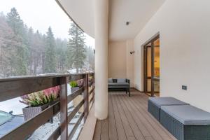 a balcony of a house with a view at Poiana Ski Residence Apartment 5 in Poiana Brasov