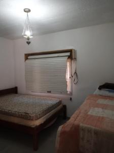 Giường trong phòng chung tại Lar doce lar +6 ảnh