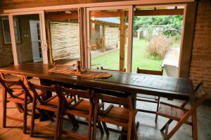 a dining room table with chairs and a large window at LORETO GUEST HOUSE YAYETOPa in Loreto