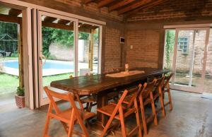 a dining room with a large wooden table and chairs at LORETO GUEST HOUSE YAYETOPa in Loreto
