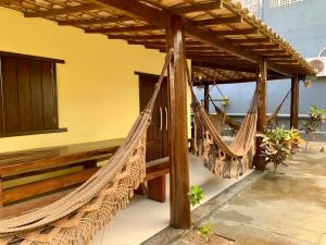 a couple of hammocks hanging from a pergola at Casa Barra Grande in Barra Grande
