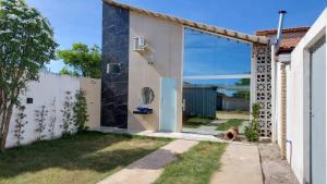 a house with a glass door in a yard at Casa praia ótimo preço in Prado