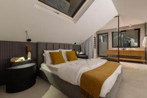 a bedroom with a large bed with yellow pillows at Santiago Beach House in Leça da Palmeira +78 photos