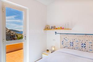 Ένα ή περισσότερα κρεβάτια σε δωμάτιο στο Villa Josephine - Sardinia Unlimited