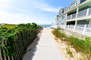 a walkway leading to a beach house at Edgewater Beach Resort in Dennis Port