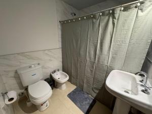 a bathroom with a toilet and a sink and a shower at Doña Mercedes in Verónica +12 photos