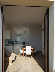 a living room with a table and a kitchen at Sicalindeè in Zollino +16 photos