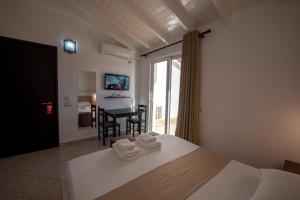 a bedroom with a bed with folded towels on it at Mariksel HOTEL in Ksamil