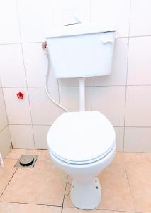 a bathroom with a white toilet and a sink at La Casa De Papel Morogoro Apartment by Monalisa in Morogoro