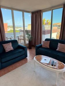 a living room with two couches and a coffee table at Penthouse - Jacuzzi - Terrace - Parking - 2 pools in Antibes