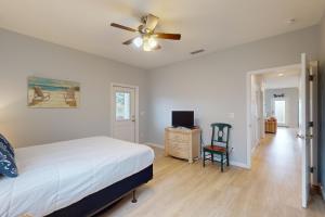 a bedroom with a bed and a ceiling fan at Knot a Care in Mexico Beach