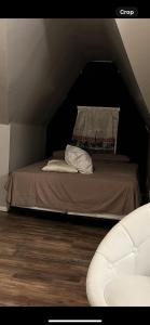 a bed in a attic with a pillow on it at BVF2Bedroom in Harrisburg