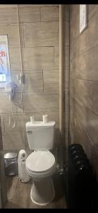 a bathroom with a white toilet and a phone at BVF2Bedroom in Harrisburg