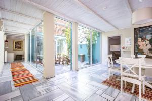 an open living room with glass doors and a table and chairs at Corinthian Blue Retreat in Katakoúli