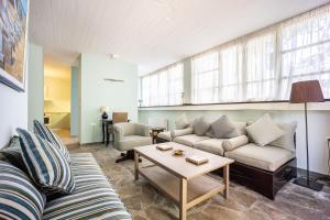 a living room with a couch and a table at Corinthian Blue Retreat in Katakoúli