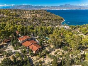 an aerial view of a house with trees and the ocean at Corinthian Blue Retreat in Katakoúli