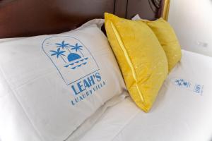 a bed with a pillow with a sign on it at Leah's Luxury Villa in Mombasa