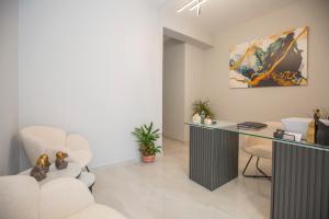 a living room with a desk and a chair at Pomaria Boutique Residences in Lefkada