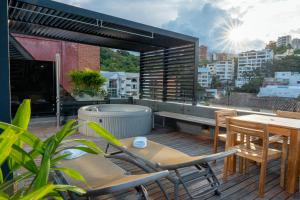 a patio with a table and chairs on a balcony at Hotel Foresto 365 in Cali