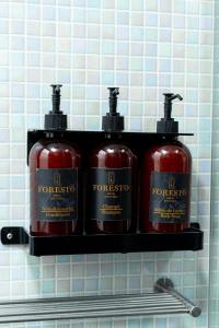 a shelf with four fire hydrants on a wall at Hotel Foresto 365 in Cali