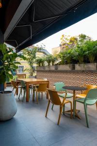 a group of tables and chairs on a patio at Hotel Foresto 365 in Cali +34 photos
