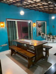 a wooden piano in a room with a blue wall at Recanto das Oliveiras in Corumbau