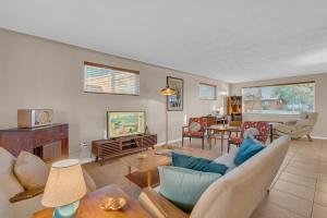 a living room with a couch and a table at Retro 50's mid century modern home in Tucson