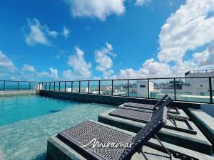 a swimming pool on the roof of a building at Get By Side 50 Metros da Praia - Jardim Oceania in João Pessoa