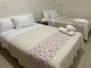 two beds sitting next to each other in a room at Casita Cocoa in Santa Cruz Huatulco +6 photos