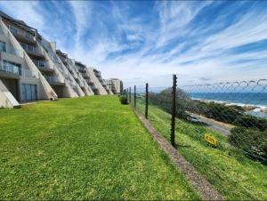 a fence in front of a building next to the ocean at 13 Chesapeake Bay in Margate