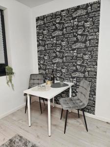 a table and two chairs in front of a wall at DoubleC in Galaţi
