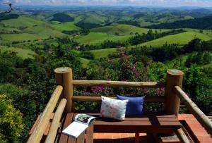 a bench sitting on top of a hill with a view at Pousada Quinta da Serra in Cunha