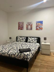 a bedroom with a bed and paintings on the wall at Bang Bang in Lisbon