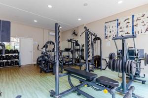 a gym with several tread machines in a room at Boulevard Bombinhas - Apto em Condomínio com Piscina e Jacuzzi in Bombinhas