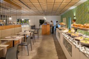 a restaurant with tables and a buffet line with food at Oasis Lanz Beach Mate in Costa Teguise